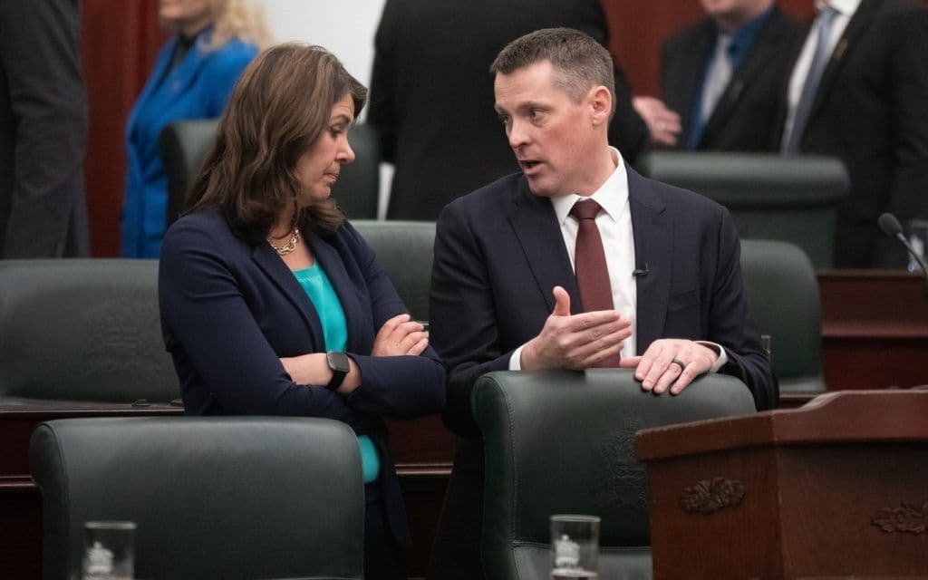 Premier Danielle Smith Speaking to Minister Nate Horner in the Alberta Legislature